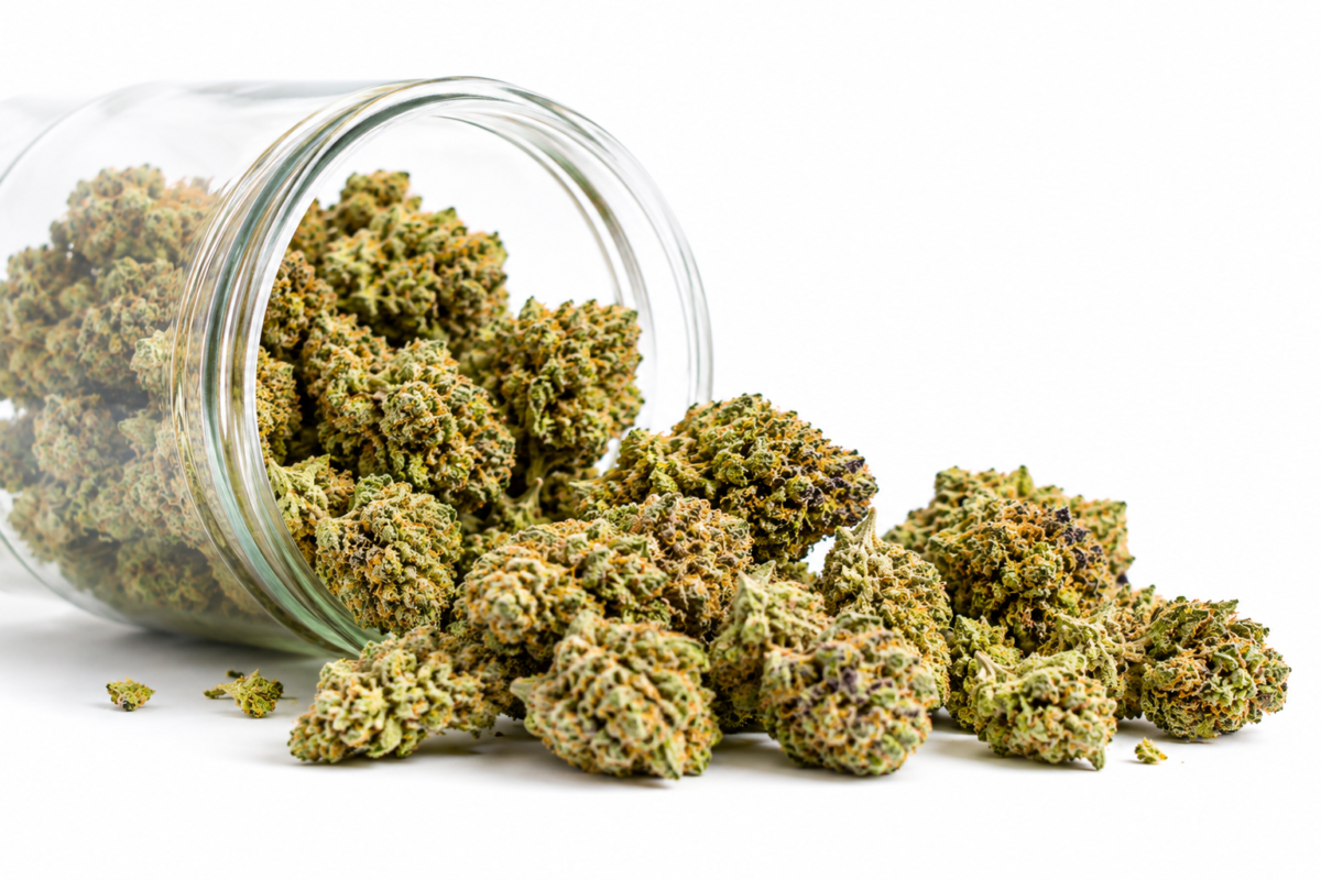 High-grade cannabis buds in a glass jar on a white background